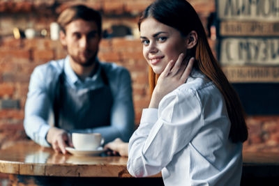 Young couple sitting on table