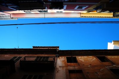 Low angle view of built structure against blue sky