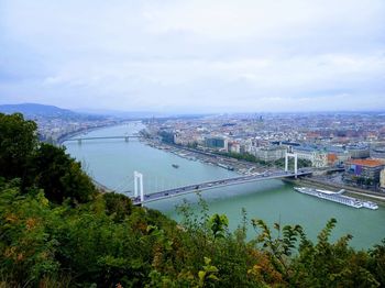 High angle view of bridge over river in city against sky