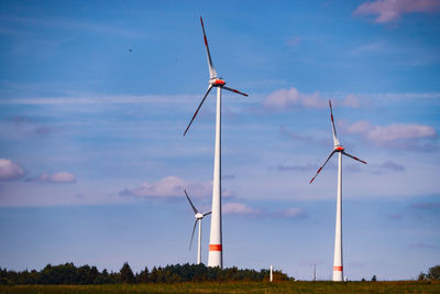 Low angle view of windmill against sky