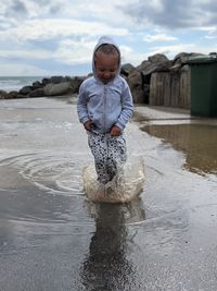 Girl jumping in puddle 