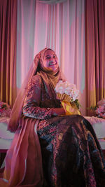 A woman wearing traditional clothing wedding for malaysian