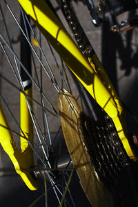 Full frame shot of yellow bike frame and wheel detail 