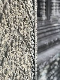 Close-up of buddha statue against building