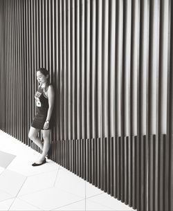 Side view of woman looking at wall