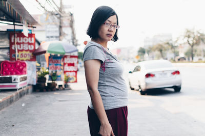 Woman standing on street in city