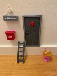 Red balloons on table against wall