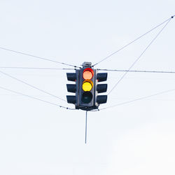 Low angle view of road sign against clear sky