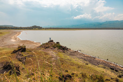 A hiker on a scenic lookout at lake elementaita in soysambu conservancy in naivasha,