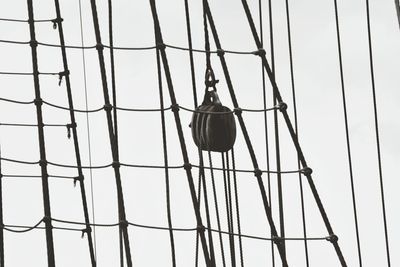 Low angle view of power lines against clear sky