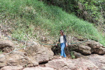 Woman standing on rock in forest