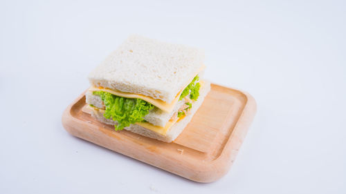 High angle view of food on cutting board against white background