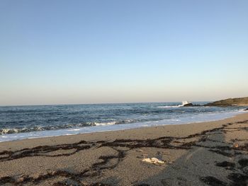 Scenic view of beach against clear sky