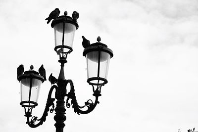 Low angle view of lamp on street light against sky