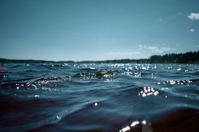 Surface level of sea against blue sky