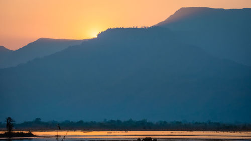 Scenic view of landscape against sky during sunset