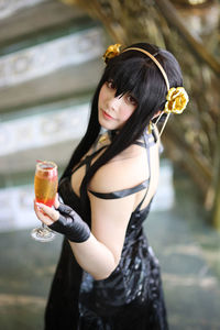 Smiling young woman drinking water