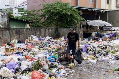 Man walking by garbage dump