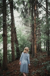 Rear view of girl walking in forest