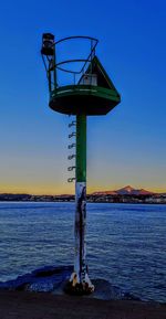 Lifeguard hut on beach against blue sky