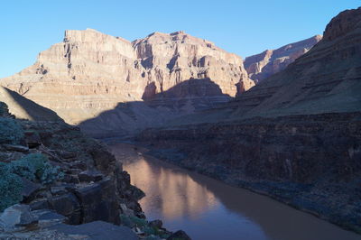 Low angle view of rock formation in lake against sky