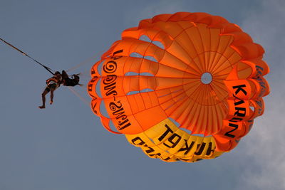 Low angle view of lanterns hanging against sky