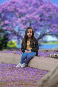 Portrait of a smiling young woman sitting outdoors