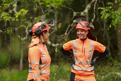 Female lumberjacks smiling in forest