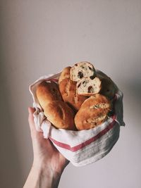 Midsection of woman holding ice cream against white background