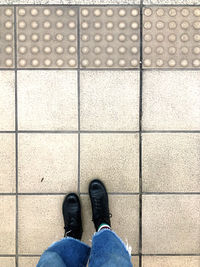 Low section of man standing on footpath