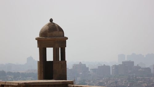 View of bell tower in city against sky