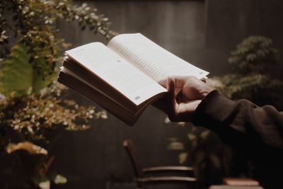 Cropped hand holding book