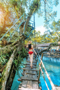 Young asian tourists enjoying the blue lagoon in vang vieng, laos