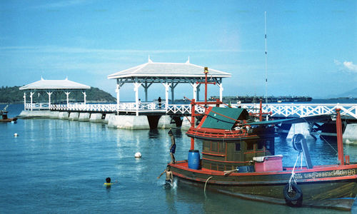 Ship moored in sea against sky