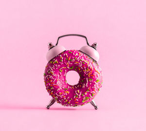 Close-up of donut against pink background