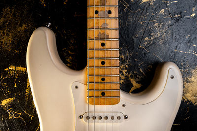 Close-up of guitar against wall