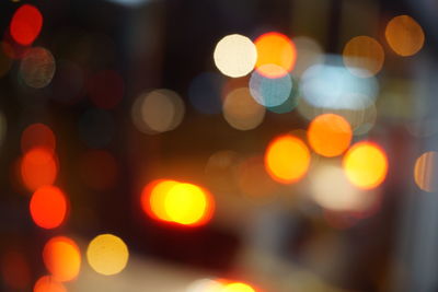 Defocused image of illuminated christmas lights at night