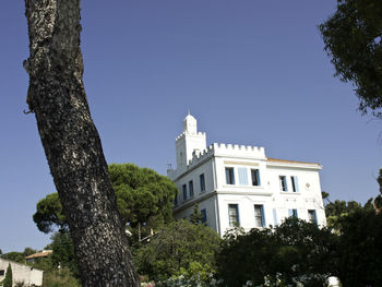 Low angle view of building against clear blue sky