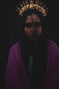 Portrait of mid adult man against black background