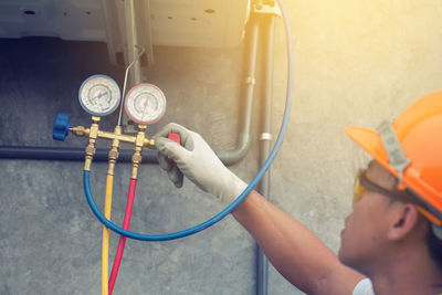 Worker looking at pressure gauge