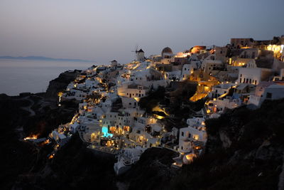 High angle view of townscape by sea against sky