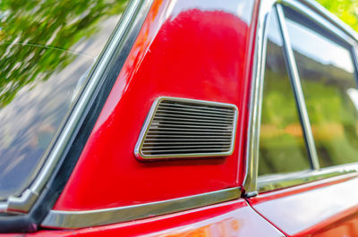 Ventilation from outside on lada car. close-up of ventilation grill on red car.