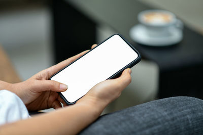 Midsection of man using mobile phone