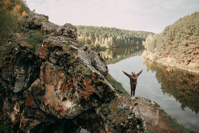 Rear view of man standing on rock