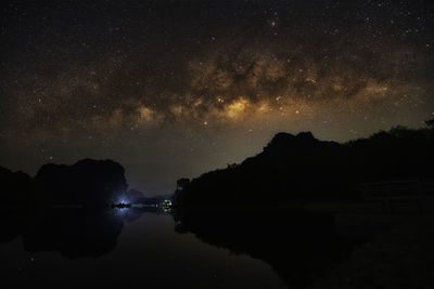 Scenic view of lake against sky at night