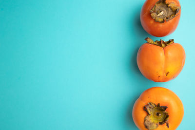 Directly above shot of orange fruit against blue background