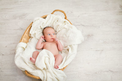 High angle view of baby boy lying on toy