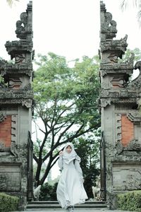 Portrait of woman standing at temple