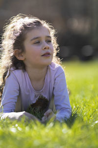 Portrait of young woman sitting on field