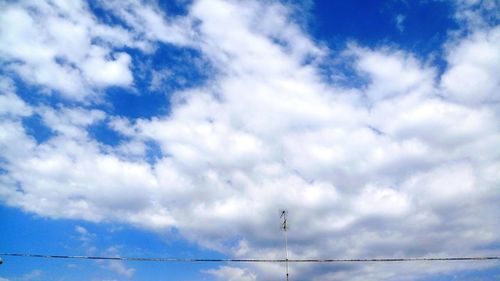 Low angle view of birds flying against sky